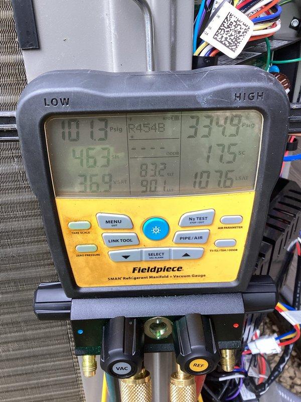 Responded to no cooling complaint on 3-month-old Lennox system utilizing R454B refrigerant with short cycling issue and error code 422. Upon arrival, found outdoor unit heavily obstructed with cottonwood debris blocking airflow to condenser coil. Indoor temperature holding at 79°F with compressor cycling off while fan continued to run.

Performed thorough inspection and diagnostic testing. Cleaned condenser coil by rinsing down unit to remove cottonwood blockage and checked air filter. Initial refrigerant readings showed abnormal pressures: low side 87 PSI with 54°F superheat and 29°F vapor saturation temperature; high side 336 PSI with 16°F subcooling and 107°F liquid saturation temperature. Delta-T measured only 14°F, indicating insufficient cooling capacity.

Due to improper refrigerant charge and system performance issues, recovered 6 pounds 10 ounces of R454B refrigerant from system. Evacuated and recharged system with fresh refrigerant at proper weight of 6 pounds 10 ounces per m