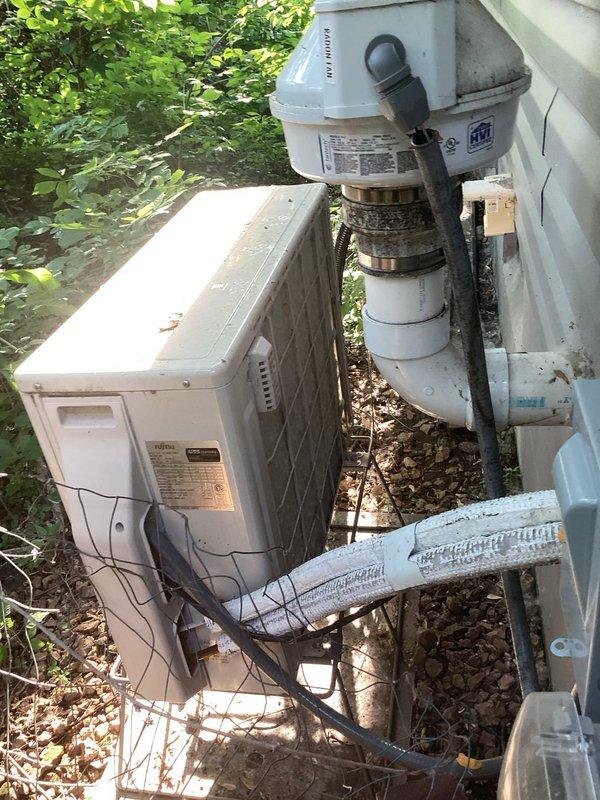 # HVAC Service Completed

Responded to service call for wall-mounted mini-split system not cooling adequately. Upon arrival, performed visual inspection of both indoor evaporator unit and outdoor condensing unit. Removed front cover of indoor unit to access evaporator coil and internal components. Observed accumulated dust and debris on interior surfaces indicating lack of recent maintenance.

Proceeded to outdoor unit location to assess condenser operation and refrigerant system. Noted aged appearance of equipment with visible weathering and surface discoloration. Connected manifold gauges to service ports and performed refrigerant pressure analysis. Testing confirmed system was operating with low refrigerant charge, resulting in reduced cooling capacity.

Identified refrigerant leak as root cause of low charge condition. Inspected refrigerant line connections, service ports, and coil assemblies for signs of leakage. Due to age of equipment and existing warranty complications with ano
