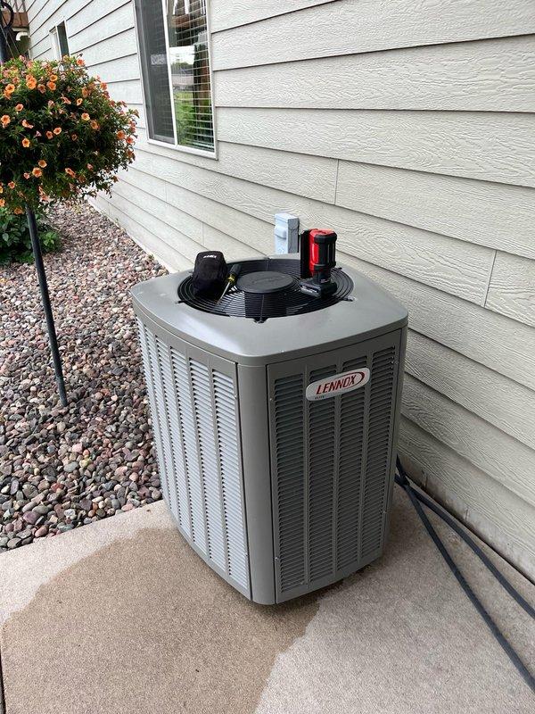 Performed preventative maintenance tune-up on 4-year-old Lennox air conditioning system. Inspected indoor unit and found air filter and blower assembly in clean condition. Evaporator coil was clean but showed minor water accumulation in drain pan. Outdoor condensing unit was heavily soiled with debris. All electrical components tested within manufacturer specifications. Cleared evaporator drain line blockage and thoroughly cleaned condenser coil. Conducted operational test with 15-minute runtime, confirming proper system function with 15-18 degree temperature split across evaporator coil, meeting performance standards.