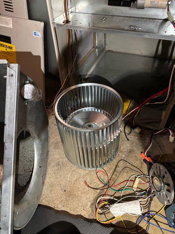 Responded to service call for residential oil furnace system experiencing blower failure. Upon inspection, identified failed blower motor with oil leakage and broken blower wheel requiring immediate replacement. Removed defective components and installed new blower motor and wheel assembly. After installation, started and tested the air conditioning system to verify proper operation. System ran normally with no abnormal blower noise or performance issues observed at time of departure.