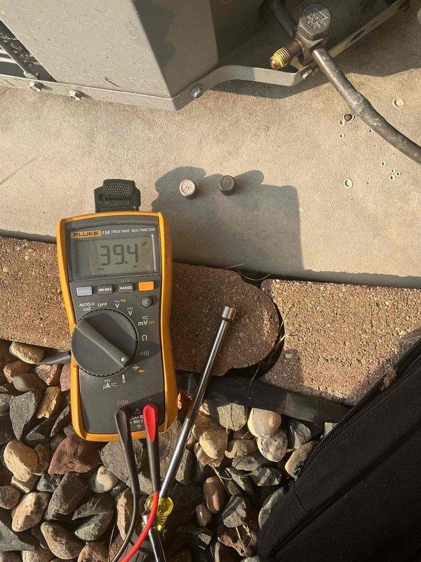 Responded to no cooling complaint on 19-year-old Comfortmaker air conditioning system with indoor fan running continuously despite thermostat set to auto mode. Upon arrival, discovered outdoor unit breaker in off position; restored power and unit immediately resumed operation. Performed comprehensive system evaluation revealing capacitor reading out of manufacturer specifications on compressor terminal and electrical contactor showing moderate pitting on contact points. Measured refrigerant charge within acceptable range, confirmed both condenser and evaporator coils clean, documented elevated starting amperage with normal running amperage, and verified proper system performance with 22-degree temperature split across evaporator coil. Discussed equipment condition, available repair options, and system longevity considerations with homeowners given age of unit and identified component wear.