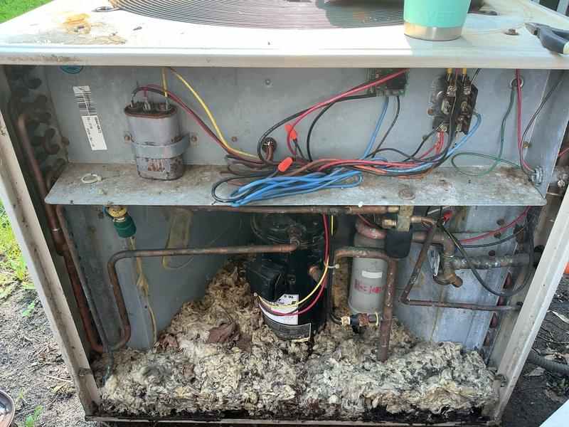 Responded to no cooling complaint on 32-year-old residential air conditioning system. Upon inspection, found failed capacitor and replaced unit. System remained inoperative due to high pressure safety switch lockout that could not be reset through normal procedures. Bypassed high pressure switch as temporary measure to restore cooling operation. Advised customer this is a temporary repair without guarantee due to underlying system issues and age of equipment. Observed significant debris accumulation in outdoor unit cabinet and general wear consistent with three decades of operation. System currently operational but requires replacement due to age and compromised safety controls.