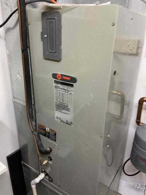 Responded to no cooling call on 10+ year old Trane air handler. Upon arrival, diagnosed failed blower motor preventing airflow while unit remained cold to touch. Successfully replaced defective blower motor and restored system operation.