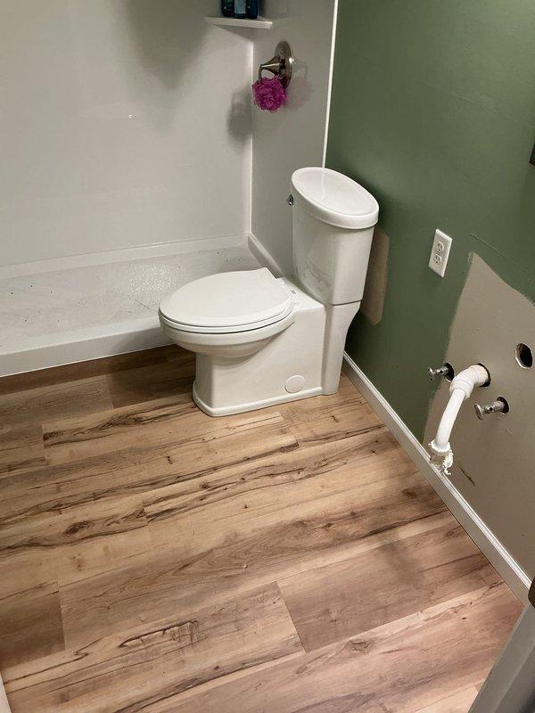 Responded to service call for two toilet installations following customer's removal of basement toilet after new flooring installation. Successfully completed installation of first toilet in bathroom with new laminate flooring, ensuring proper seating, seal integrity, and secure mounting to flange. Second toilet location required additional work beyond initial scope; performed inspection of flange condition and subfloor preparation, noting rust staining and potential flange repair needs. Provided estimate for completion of second toilet installation with necessary preparatory repairs.