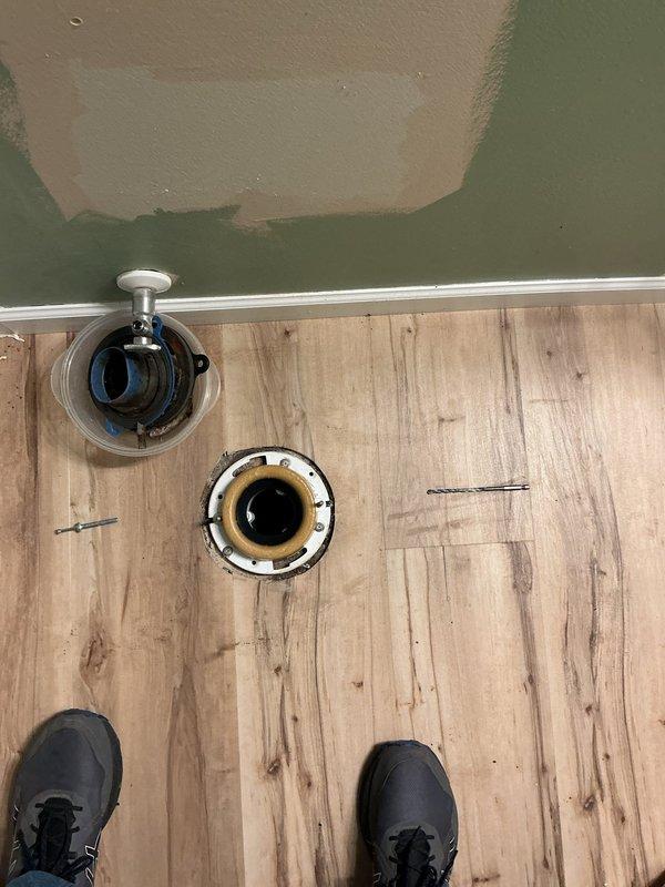 Responded to service call for two toilet installations following customer's removal of basement toilet after new flooring installation. Successfully completed installation of first toilet in bathroom with new laminate flooring, ensuring proper seating, seal integrity, and secure mounting to flange. Second toilet location required additional work beyond initial scope; performed inspection of flange condition and subfloor preparation, noting rust staining and potential flange repair needs. Provided estimate for completion of second toilet installation with necessary preparatory repairs.