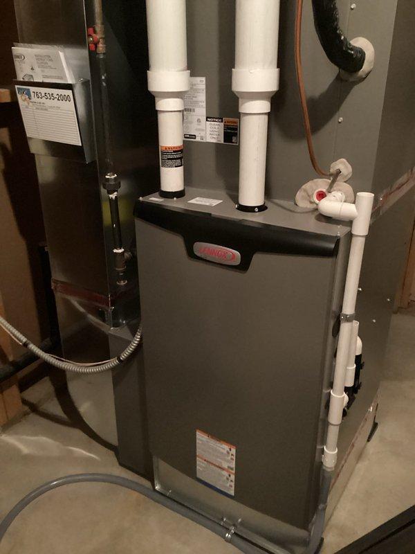 Responded to service call for water heater inspection following concerns noted on home inspection report regarding potential exhaust issues and melted plastic on top of unit. Upon arrival, performed thorough visual inspection of Rheem tanked water heater installation and all associated components. Examined exhaust venting system, flue pipe connections, and draft hood assembly for proper operation and clearance compliance. Inspected furnace exhaust system with PVC intake and exhaust vents to rule out any cross-contamination or backdrafting concerns. Verified water heater is conventional atmospheric vent unit, not power vent configuration. Checked all copper supply line connections, temperature and pressure relief valve, and gas line connections for leaks or defects. Evaluated combustion air supply and clearances to combustible materials per manufacturer specifications. Documented installation with photographs showing water heater, furnace system, venting configuration, and utility room 