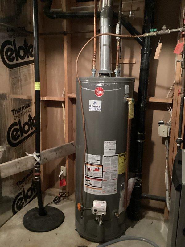 Responded to service call for water heater inspection following concerns noted on home inspection report regarding potential exhaust issues and melted plastic on top of unit. Upon arrival, performed thorough visual inspection of Rheem tanked water heater installation and all associated components. Examined exhaust venting system, flue pipe connections, and draft hood assembly for proper operation and clearance compliance. Inspected furnace exhaust system with PVC intake and exhaust vents to rule out any cross-contamination or backdrafting concerns. Verified water heater is conventional atmospheric vent unit, not power vent configuration. Checked all copper supply line connections, temperature and pressure relief valve, and gas line connections for leaks or defects. Evaluated combustion air supply and clearances to combustible materials per manufacturer specifications. Documented installation with photographs showing water heater, furnace system, venting configuration, and utility room 
