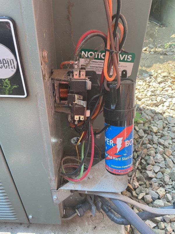 Responded to no cooling complaint on 14-year-old air conditioning system. Upon inspection, discovered burnt wiring at capacitor caused by hard start kit wires contacting high voltage power supply. Rewired electrical connections to capacitor and hard start kit, ensuring proper separation from high voltage components. Cleaned condenser coil to improve heat transfer efficiency. 

Performed refrigerant system diagnostics using manifold gauges, which revealed low subcooling readings indicating refrigerant leak in system. Based on service history showing previous recharge without leak repair and current age of equipment, recommended system replacement. Scheduled same-day estimate for new air conditioning installation.