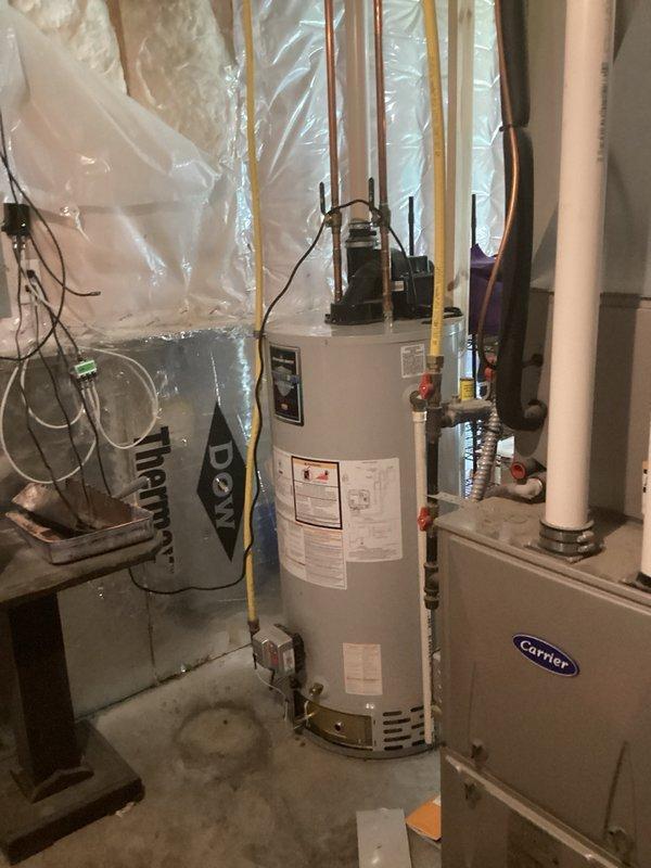 Responded to no hot water complaint on 50-gallon natural gas water heater. Upon inspection, identified failed pilot assembly preventing proper ignition and discovered pinhole leak in tank. Bradford White water heater manufactured in 2009 deemed beyond economical repair due to tank integrity compromise. Documented equipment condition with photographs and provided estimate for complete water heater replacement.