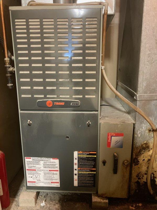 Responded to no cooling call on 15+ year old residential AC system. Upon inspection, found refrigerant charge completely depleted and furnace non-operational for several years. Given the advanced age of the equipment and the cost of necessary repairs versus replacement, recommended and customer approved full system replacement. Documented existing Trane XV80 furnace installation and overall condition of basement mechanical room equipment prior to replacement work.
