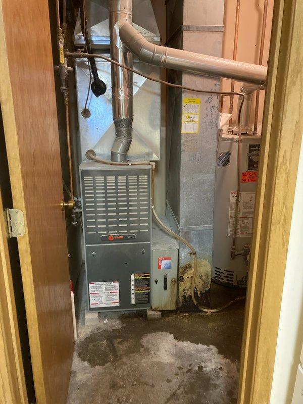 Responded to no cooling call on 15+ year old residential AC system. Upon inspection, found refrigerant charge completely depleted and furnace non-operational for several years. Given the advanced age of the equipment and the cost of necessary repairs versus replacement, recommended and customer approved full system replacement. Documented existing Trane XV80 furnace installation and overall condition of basement mechanical room equipment prior to replacement work.