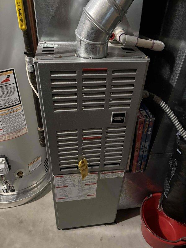 Performed comprehensive AC maintenance on a 10-year-old system with R-410A refrigerant under 90-degree ambient conditions. Conducted thorough inspection and tune-up of one Lennox outdoor condensing unit and Carrier indoor air handler, including filter evaluation, thermostat operation verification, temperature split measurement, condenser coil cleaning, motor inspection, capacitor testing, compressor assessment, refrigerant charge verification, and condensate drain check. All components tested within normal operating parameters with no deficiencies noted; system cooling effectively at time of service completion.