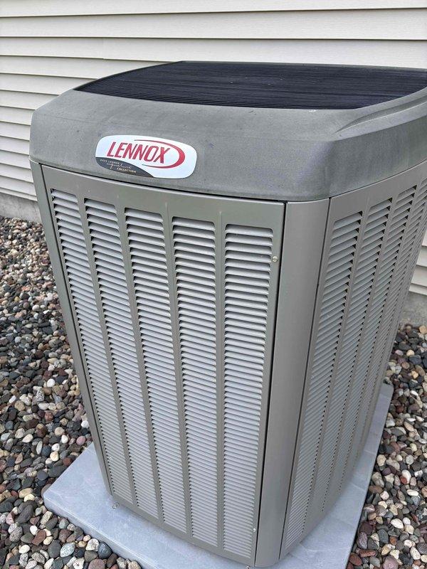 Performed comprehensive AC maintenance on a 10-year-old system with R-410A refrigerant under 90-degree ambient conditions. Conducted thorough inspection and tune-up of one Lennox outdoor condensing unit and Carrier indoor air handler, including filter evaluation, thermostat operation verification, temperature split measurement, condenser coil cleaning, motor inspection, capacitor testing, compressor assessment, refrigerant charge verification, and condensate drain check. All components tested within normal operating parameters with no deficiencies noted; system cooling effectively at time of service completion.