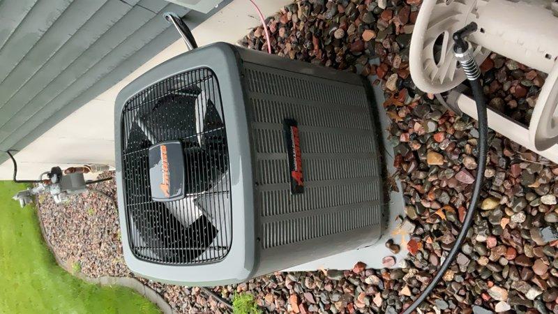 Responded to no cooling complaint on 2021 Amana air conditioning system with condenser fan running but no interior cooling. Diagnostic testing revealed failed dual run capacitor rated 40/5 µF—compressor section measured 0 µF while fan section read 5 µF. Replaced defective capacitor with new 40/5 µF unit, restarted system, and verified proper operation with 20°F supply/return temperature split after ten minutes of runtime. System restored to normal cooling operation.