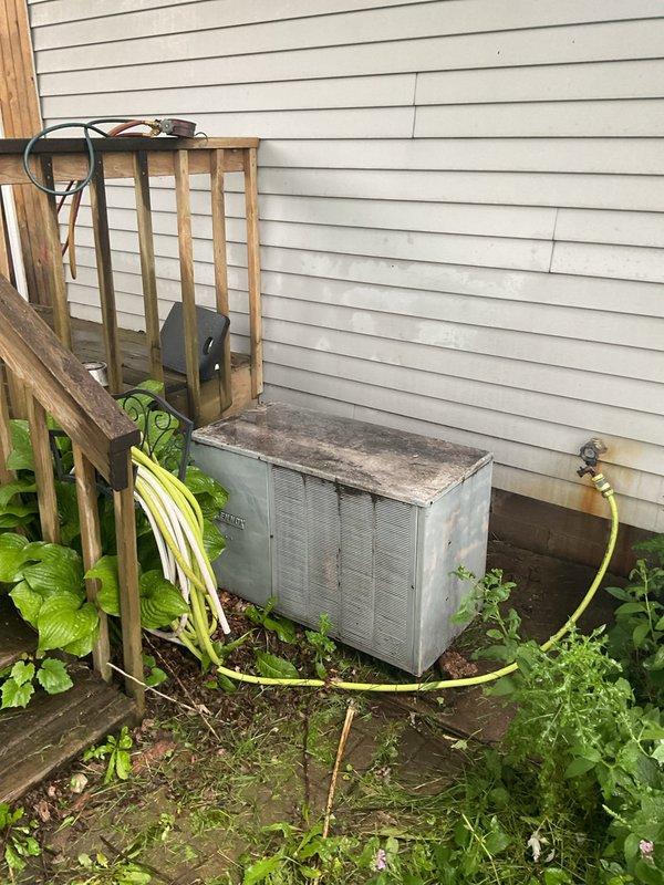 Responded to no cooling call and found approximately 50-year-old outdoor condensing unit with severely damaged electrical wiring feeding the equipment, with exposed bare conductors creating an unsafe condition that prevented system operation. Checked refrigerant static pressure at 120 psi, which does not confirm adequate charge without system running. Advised customer of immediate electrical hazard requiring licensed electrician to install new disconnect box and supply wiring before unit can be safely energized and further diagnosed. Documented equipment condition with photos and coordinated comfort advisor visit for replacement evaluation given age and condition of system.