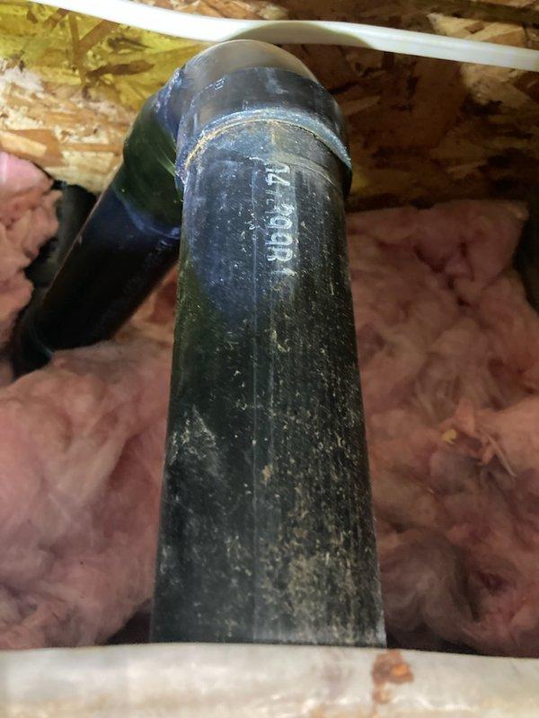 Responded to a water leak in the basement originating from the kitchen drain line above. Performed investigative access by cutting into the ceiling to locate the source. Identified a cracked ABS 90-degree elbow fitting on the kitchen sink drain line. Removed the damaged fitting and replaced it with a new 90-degree elbow using a Fernco flexible coupling to ensure a watertight seal. The leak has been successfully repaired and the drainage system restored to proper operation.