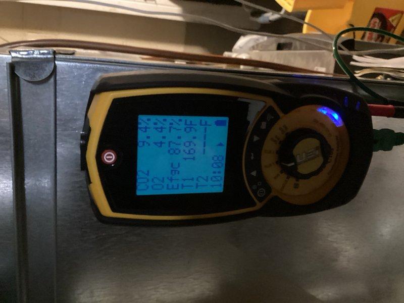 Responded to callback for IBC combination boiler system installed within the past year that intermittently lost domestic hot water production after multiple showers, displaying "purging" status on control panel. Upon inspection, found system water level below minimum operating threshold. Filled system to proper level, purged air from hydronic loops serving both radiant floor heating and domestic hot water circuits, and verified igniter and combustion components operating within specification. Cycled system through both heating modes to confirm proper operation, checked combustion analysis readings, and verified all functions restored to normal parameters.