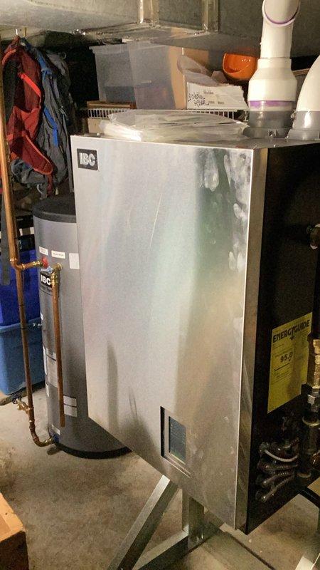 Responded to callback for IBC combination boiler system installed within the past year that intermittently lost domestic hot water production after multiple showers, displaying "purging" status on control panel. Upon inspection, found system water level below minimum operating threshold. Filled system to proper level, purged air from hydronic loops serving both radiant floor heating and domestic hot water circuits, and verified igniter and combustion components operating within specification. Cycled system through both heating modes to confirm proper operation, checked combustion analysis readings, and verified all functions restored to normal parameters.
