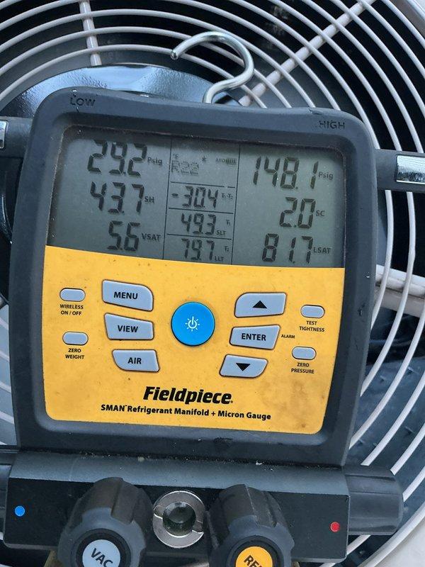 Responded to no cooling complaint on 10+ year old R22 air conditioning system that had previously frozen up. Upon arrival, system had been off and evaporator coil was fully thawed. Performed diagnostic testing using refrigerant manifold and gauges, which revealed system was significantly low on R22 refrigerant charge. Measured operating pressures and temperatures on both low and high side of system. Low refrigerant charge was determined to be primary cause of freezing and loss of cooling capacity. Added R22 refrigerant to bring system back to proper operating charge levels. Verified proper system operation with corrected pressures and temperatures after recharge. System restored to normal cooling operation.