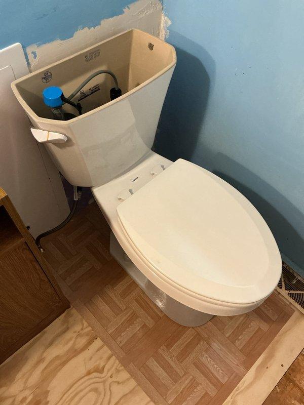 Completed installation of new ADA-compliant elongated toilet per estimate specifications. Replaced existing toilet flange to ensure proper seal and stability. All internal tank components, including fill valve and flush valve assembly, were installed and tested for proper operation. Work included removal of old fixture, preparation of mounting surface, and secure installation of new two-piece toilet unit with all necessary hardware and wax ring seal. System was tested and verified to be functioning correctly with no leaks detected at supply line or base connections.