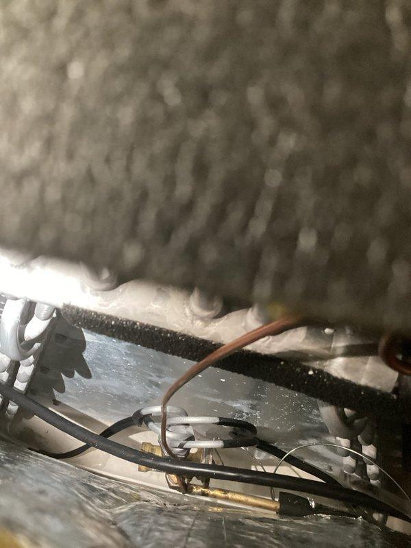 Responded to no cooling complaint on commercial AC unit installed 11 months prior. Found system completely flat on refrigerant with no pressure detected. Recharged system to manufacturer specifications and injected UV leak detection dye into refrigerant circuit. System restored to operational status temporarily, but follow-up visit required to locate and repair refrigerant leak using UV detection equipment once dye has circulated through system.