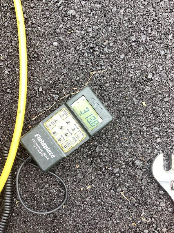Responded to no cooling complaint on commercial AC unit installed 11 months prior. Found system completely flat on refrigerant with no pressure detected. Recharged system to manufacturer specifications and injected UV leak detection dye into refrigerant circuit. System restored to operational status temporarily, but follow-up visit required to locate and repair refrigerant leak using UV detection equipment once dye has circulated through system.