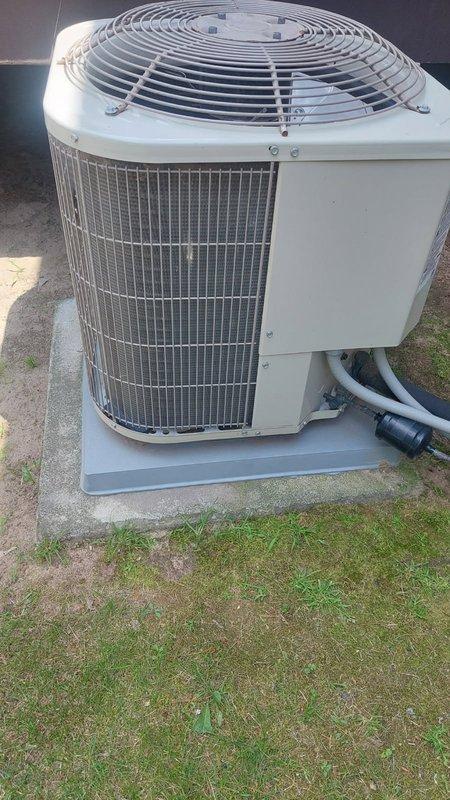 Responded to no cooling complaint on 10+ year old residential AC unit. Upon arrival, found system running with indoor blower operational and outdoor condenser fan running, but unit blowing warm air. Diagnosed severely restricted condenser coil with minimal airflow through top discharge, causing inadequate heat rejection and loss of cooling capacity.

Performed complete system tune-up with customer authorization. Disassembled outdoor unit housing and thoroughly cleaned condenser coil, removing accumulated dirt and debris. Flushed coil until completely clear and airflow restored to proper levels. 

During electrical inspection, tested dual run capacitor and found readings below manufacturer specifications. Recommended immediate replacement to prevent compressor failure and potential service callback. Installed new capacitor rated to OEM specifications.

Reassembled unit and conducted operational testing. Verified proper compressor amperage, fan operation, and refrigerant pressures. Measu