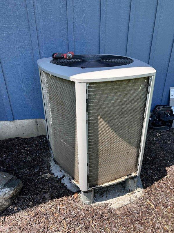 Responded to no cooling complaint with system blowing warm air and indoor temperature at 78 degrees. Found condenser coil heavily soiled with debris, restricting airflow and reducing system efficiency. Performed thorough condenser coil cleaning by rinsing accumulated dirt and debris from exterior surfaces. Conducted maximum cooling performance test, measuring an 18-degree temperature split across the evaporator coil, which falls within acceptable range. Verified refrigerant charge by checking subcooling levels, which measured slightly low but determined no adjustment necessary due to adequate temperature split indicating proper system operation. System restored to normal cooling operation following condenser coil cleaning.