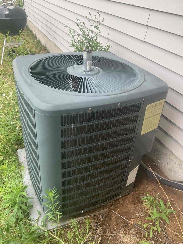 Responded to no cooling call on 10+ year old residential air conditioning system. Upon arrival, found outdoor condenser unit humming with heat discharging from top but fan motor not operating. Performed diagnostic testing and identified failed capacitor preventing fan motor operation. Replaced defective capacitor with proper OEM replacement. Verified system operation with digital manifold gauges, confirming proper pressures and temperatures. Unit restored to normal cooling operation with condenser fan running properly.
