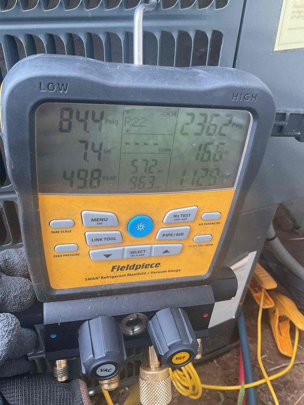 Responded to no cooling call on 10+ year old residential air conditioning system. Upon arrival, found outdoor condenser unit humming with heat discharging from top but fan motor not operating. Performed diagnostic testing and identified failed capacitor preventing fan motor operation. Replaced defective capacitor with proper OEM replacement. Verified system operation with digital manifold gauges, confirming proper pressures and temperatures. Unit restored to normal cooling operation with condenser fan running properly.