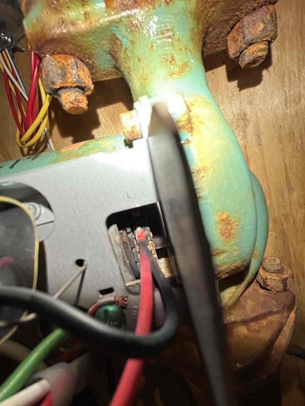Responded to no cooling call on geothermal system with circuit breaker tripping on pump circuit. Diagnosed failed zone pump inside air handler unit with corroded components and damaged flange bolts. Removed and replaced defective circulator pump, ensuring proper electrical connections and plumbing integrity. System tested and verified operational with 22°F temperature drop across coil. Upper level zone measured 85°F and lower level 82°F at time of departure. Advised system would require several hours of continuous operation to reach desired setpoint temperatures.