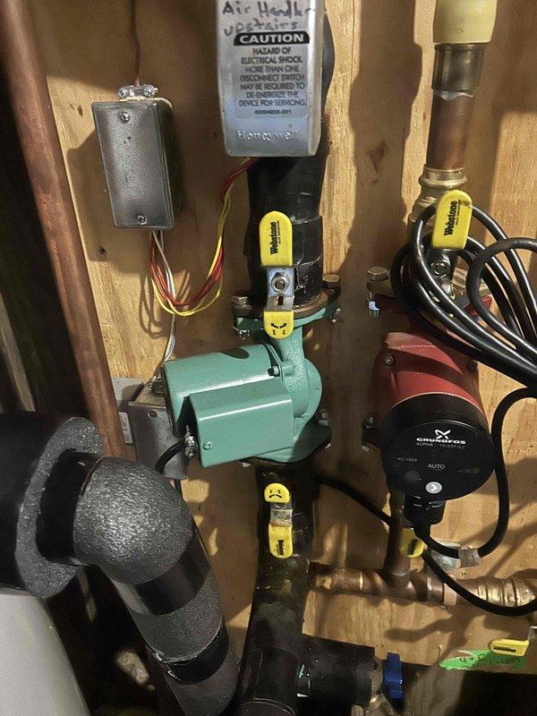 Responded to no cooling call on geothermal system with circuit breaker tripping on pump circuit. Diagnosed failed zone pump inside air handler unit with corroded components and damaged flange bolts. Removed and replaced defective circulator pump, ensuring proper electrical connections and plumbing integrity. System tested and verified operational with 22°F temperature drop across coil. Upper level zone measured 85°F and lower level 82°F at time of departure. Advised system would require several hours of continuous operation to reach desired setpoint temperatures.