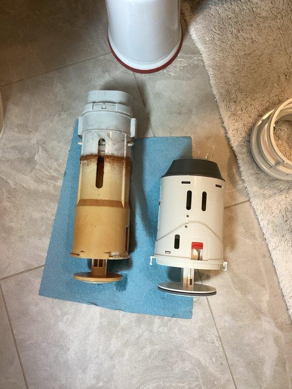 Responded to service call for toilet flush valve replacement. Upon arrival, assessed existing flush valve system and determined standard diameter valve and gaskets were required. Attempted installation of replacement flush valve mechanism; however, during rebuild process discovered the parts provided were incompatible with the existing toilet fixture. Documented the incorrect components with comparison photos showing the old deteriorated flush valve alongside the new unit to verify dimensional and mounting discrepancies. Additional parts with correct specifications will be required to complete the flush valve replacement and restore proper toilet function.