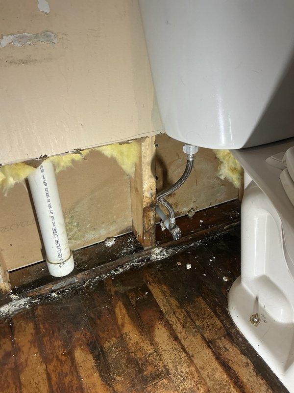 Responded to reports of PVC piping leaking in multiple locations throughout the basement. Upon arrival, conducted thorough inspection to locate source of water intrusion. Initial assessment revealed active leak originating from basement level with moisture tracking upward through structure.

Performed detailed investigation which required opening a section of wall on the main level to access concealed plumbing. Inspection revealed compromised cold water supply line feeding toilet fixture. The braided flex supply line connection showed signs of failure, resulting in water seepage behind wall cavity and subsequent damage to surrounding building materials including insulation, drywall, and flooring.

Isolated water supply to affected area and removed failed supply line. Installed new braided stainless steel flex connector to cold water supply feeding toilet. Verified all connections were secure and leak-free. Restored water supply and pressure-tested repair to ensure proper function. Conf