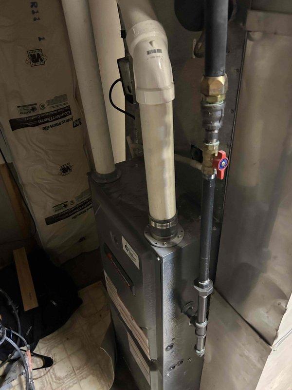 Responded to no cooling complaint on residential air conditioning system. Upon arrival, found evaporator coil completely iced over. Activated furnace heat mode to thaw frozen coil. After thaw cycle completed, verified airflow was adequate throughout system. Connected manifold gauges and performed refrigerant charge analysis, revealing system was significantly low on refrigerant charge. Added approximately 2 pounds of refrigerant to restore proper system operation. Verified unit was cooling properly upon departure. Discussed with homeowner potential need for future leak detection and repair services given the low refrigerant condition on this aging system.