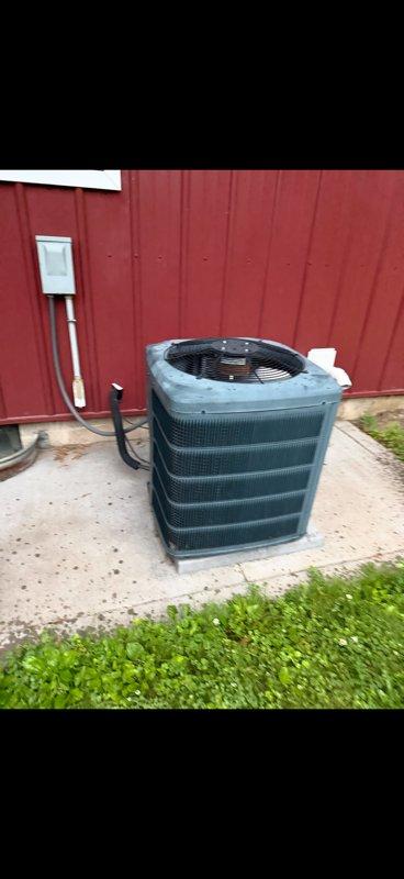 Responded to no cooling complaint on 10+ year old system at lower rental unit. Upon arrival, found system running with excessive moisture around furnace indicating previous freeze-up condition. Verified adequate airflow and clean filters throughout system. Inspected outdoor condensing unit and discovered refrigerant charge severely low on R-410A. Contacted property owner with findings and explained system has active refrigerant leak requiring repair. Provided leak repair estimates and discussed system age considerations for future reliability. Property owner agreed to schedule equipment replacement consultation for following day.