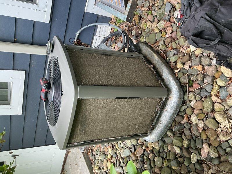 Responded to no cooling complaint on second-floor Lennox condenser unit installed in 2024. Upon arrival, both AC units were operational, but customer provided video showing compressor cycling on then immediately shutting off. Performed diagnostic testing on capacitor, contactor, and compressor components—all tested within normal parameters. Discovered condenser coils heavily obstructed with cottonwood debris, causing severe airflow restriction and compressor short-cycling. Verified refrigerant charge at proper levels. Thoroughly rinsed condenser coils to restore airflow, replaced air filter, and confirmed blower motor operating at correct speed. System restored to normal cooling operation. 

Additionally identified secondary issue with basement zone damper motor stuck in open position, causing continuous airflow to basement zone regardless of thermostat call. Verified first-floor zone damper operating correctly. Basement damper motor requires replacement to restore proper zone control 