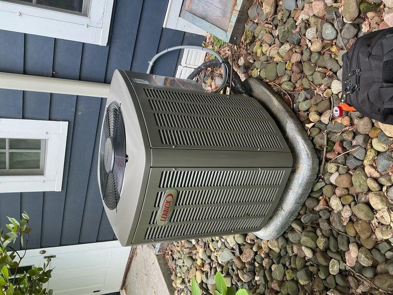 Responded to no cooling complaint on second-floor Lennox condenser unit installed in 2024. Upon arrival, both AC units were operational, but customer provided video showing compressor cycling on then immediately shutting off. Performed diagnostic testing on capacitor, contactor, and compressor components—all tested within normal parameters. Discovered condenser coils heavily obstructed with cottonwood debris, causing severe airflow restriction and compressor short-cycling. Verified refrigerant charge at proper levels. Thoroughly rinsed condenser coils to restore airflow, replaced air filter, and confirmed blower motor operating at correct speed. System restored to normal cooling operation. 

Additionally identified secondary issue with basement zone damper motor stuck in open position, causing continuous airflow to basement zone regardless of thermostat call. Verified first-floor zone damper operating correctly. Basement damper motor requires replacement to restore proper zone control 