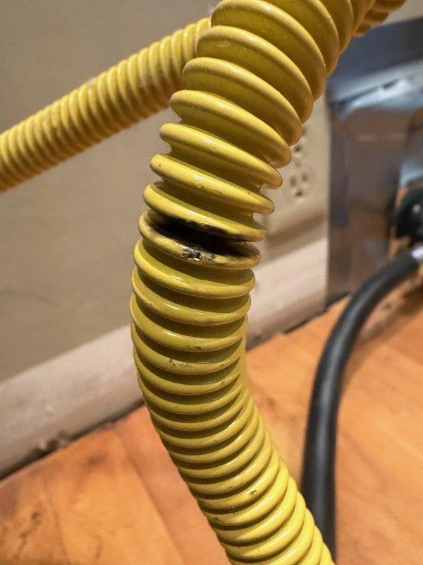 Responded to a gas line leak at the stove connection. Upon inspection, identified a pinhole leak in the flexible gas connector whip. Removed the damaged corrugated stainless steel tubing (CSST) connector and installed a new flexible gas line with proper fittings. Installed a shut-off valve for safety compliance and code requirements. Pressure tested all connections to verify leak-free operation and restored gas service to the appliance.