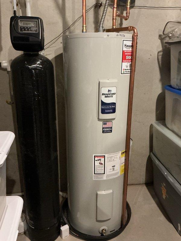 Performed follow-up service on recently installed Bradford White tanked water heater due to insufficient hot water temperature. Upon inspection, found both upper and lower thermostats set below the "hot" marking on the temperature dial. Adjusted both thermostats to settings above the "hot" position to increase water temperature output and meet household requirements.