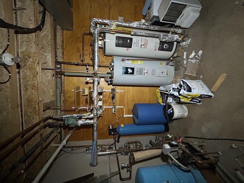 Responded to no-cooling complaint on 30-year-old air conditioning unit. Upon inspection, found compressor not operating due to failed capacitor leaking oil and rodent-damaged wiring. Repaired chewed wire and replaced defective capacitor. System restarted with outdoor fan operating, but compressor experienced delayed startup, indicating impending compressor failure. Advised customer that compressor is deteriorating and recommended obtaining replacement pricing due to age of unit and declining compressor performance.