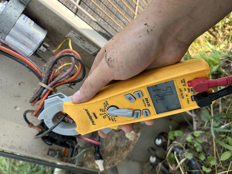 Responded to no-cooling complaint on 30-year-old air conditioning unit. Upon inspection, found compressor not operating due to failed capacitor leaking oil and rodent-damaged wiring. Repaired chewed wire and replaced defective capacitor. System restarted with outdoor fan operating, but compressor experienced delayed startup, indicating impending compressor failure. Advised customer that compressor is deteriorating and recommended obtaining replacement pricing due to age of unit and declining compressor performance.