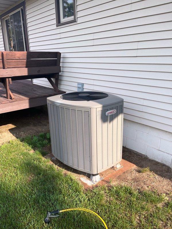 Performed comprehensive AC tune-up on 4-year-old Lennox unit. Replaced dirty air filter with customer-supplied filter, verified evaporator coil was clean with proper drainage, and confirmed blower assembly was clean. Removed wasp infestation from outdoor condenser unit and thoroughly cleaned condenser coils. Conducted operational test at maximum cooling capacity for 15 minutes, confirming proper system performance with 16-18 degree temperature split across the coil. All components operating within manufacturer specifications.