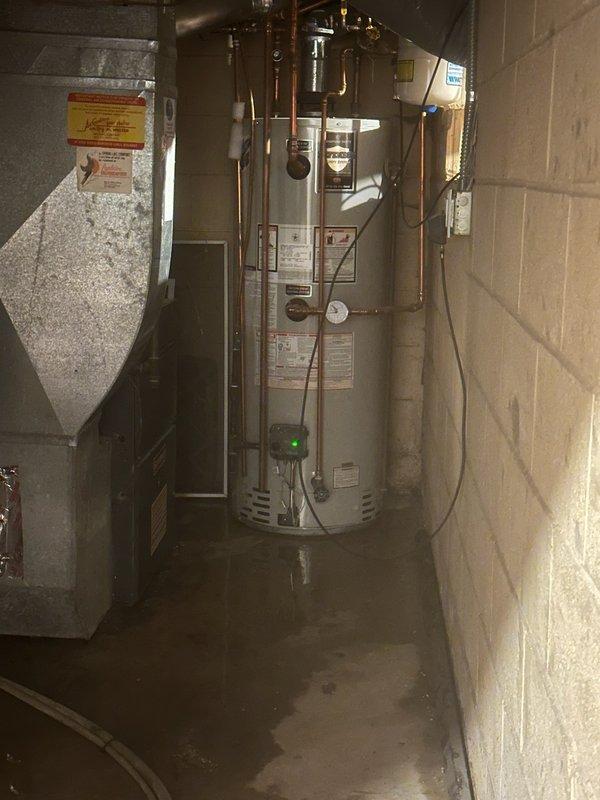 Responded to leaking overflow pipe on 11-year-old 50-gallon electric water heater. Upon arrival, water supply to home had been shut off by homeowner. Diagnosed faulty temperature and pressure relief valve as source of leak. Replaced defective T&P relief valve with new unit, restoring proper safety function and eliminating leak.