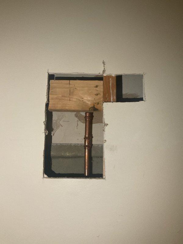 Responded to water leak emergency caused by burst outdoor spigot. Removed failed spigot and installed new frost-free hose bibb to prevent future freeze damage. Additionally addressed downstairs bathroom shower issue where corroded shower head removal resulted in broken pipe inside wall cavity, requiring wall access and pipe repair with copper fittings.