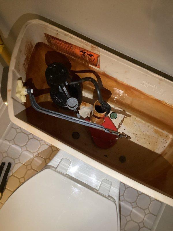 Responded to toilet malfunction where unit would not stop running and required manual shutoff at the supply valve. Upon inspection, identified failed fill valve causing continuous water flow and improper tank filling. Tank interior showed significant mineral deposits and staining consistent with age and hard water exposure. Replaced defective fill valve assembly with new unit and installed new flapper valve to ensure proper seal and flush operation. Tested system functionality to verify proper fill cycle, shutoff operation, and complete flush performance. Toilet now operates correctly with no continuous running.