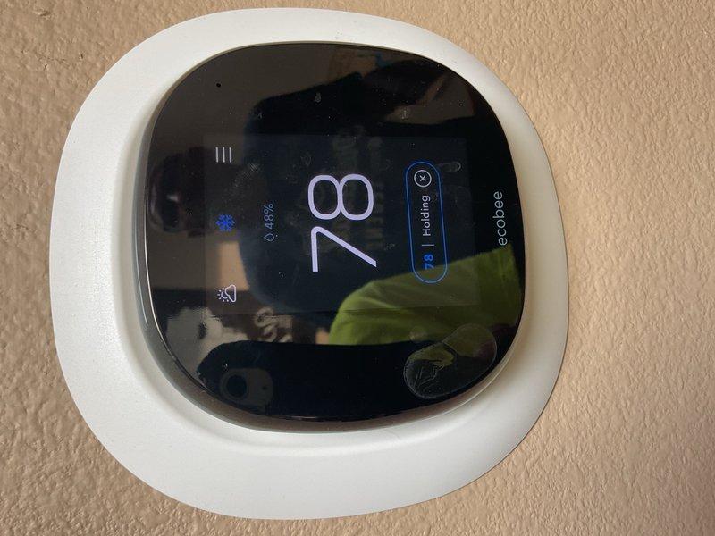 Responded to a no-cooling complaint on a 2006 Lennox air conditioning system with a factory charge of 12 lb 5 oz of R-410A. Upon arrival, found the system running continuously with inadequate cooling and rising indoor temperature reading 78°F on the thermostat. Inspected the outdoor unit and discovered the condenser coil heavily impacted with cottonwood and debris, severely restricting airflow and heat transfer capability. Performed thorough cleaning and rinsing of the condenser coil, reassembled all panels, and connected diagnostic probes to evaluate system performance. After allowing the system to stabilize for 10 minutes with an outdoor ambient temperature of 80°F, measured suction line and liquid line temperatures both at approximately 76°F with subcooling at -1°F, well below the manufacturer's specification of 8°F subcooling. These diagnostic readings confirmed the system is severely undercharged with refrigerant, indicating an active leak in the refrigerant circuit. Explained fin