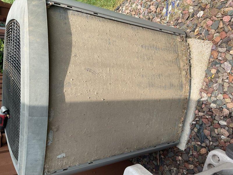 Responded to a no-cooling complaint on a 2006 Lennox air conditioning system with a factory charge of 12 lb 5 oz of R-410A. Upon arrival, found the system running continuously with inadequate cooling and rising indoor temperature reading 78°F on the thermostat. Inspected the outdoor unit and discovered the condenser coil heavily impacted with cottonwood and debris, severely restricting airflow and heat transfer capability. Performed thorough cleaning and rinsing of the condenser coil, reassembled all panels, and connected diagnostic probes to evaluate system performance. After allowing the system to stabilize for 10 minutes with an outdoor ambient temperature of 80°F, measured suction line and liquid line temperatures both at approximately 76°F with subcooling at -1°F, well below the manufacturer's specification of 8°F subcooling. These diagnostic readings confirmed the system is severely undercharged with refrigerant, indicating an active leak in the refrigerant circuit. Explained fin