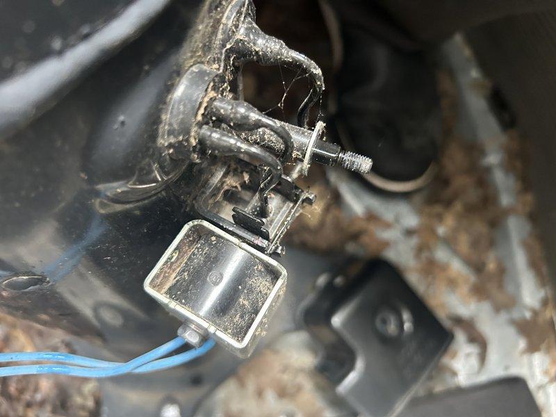 Responded to no cooling complaint on seven-year-old two-stage system with elevated indoor humidity. Diagnosed system operating normally on first stage cooling (Y1), but second stage (Y2) failing to activate. Verified 24V power present at Y2 terminal and confirmed solenoid clicking sound at compressor when second stage called, indicating electrical signal reaching unit but compressor not engaging. Used multimeter to verify voltage and monitored amperage at outdoor unit—no increase in amp draw when transitioning to second stage. Checked refrigerant pressures which remained unchanged between stage one and stage two operation, confirming compressor not running. Attempted mechanical troubleshooting of solenoid valve without success. Determined compressor internal solenoid valve failure preventing second stage operation. Documented findings with photos of electrical testing and compressor components showing age-related corrosion. Recommended compressor replacement under manufacturer warranty