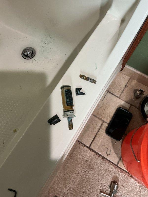 Responded to a dripping shower valve in the master bathroom where the homeowner had unsuccessfully attempted to resolve the issue by replacing the handle. Upon inspection, diagnosed a failed Moen cartridge within the valve body and noted significant verdigris corrosion on the valve assembly indicating advanced oxidation of the brass components. Presented options to either replace the entire valve assembly due to the deteriorating condition or proceed with cartridge replacement as a temporary solution. Per customer decision, removed the defective cartridge, installed a replacement Moen cartridge, and performed leak testing to verify proper operation and confirm the drip had been eliminated.